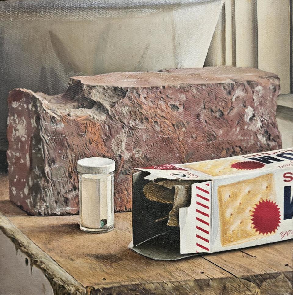 An oil painting of a box of crackers, a clear pill case with a single pill, a chipped red brick and a decorated bowl.