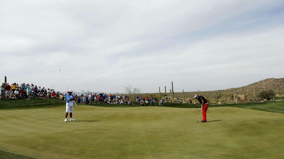 Victor Dubuisson, of France, putts on the seventh hole in his match against Bubba Watson during the third round of the Match Play Championship golf tournament on Friday, Feb. 21, 2014, in Marana, Ariz. (AP Photo/Matt York)