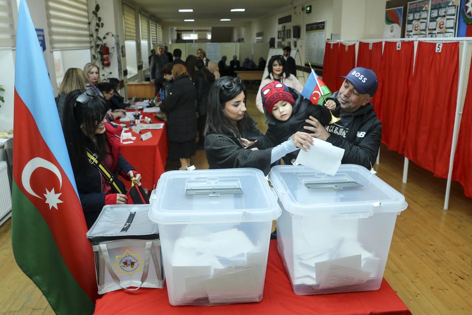 People vote at a polling station during presidential election in Baku, Azerbaijan, Wednesday, Feb. 7, 2024. Azerbaijanis are voting Wednesday in an election almost certain to see incumbent President Ilhan Aliyev chosen to serve another seven-year term. (AP Photo/Aziz Karimov)