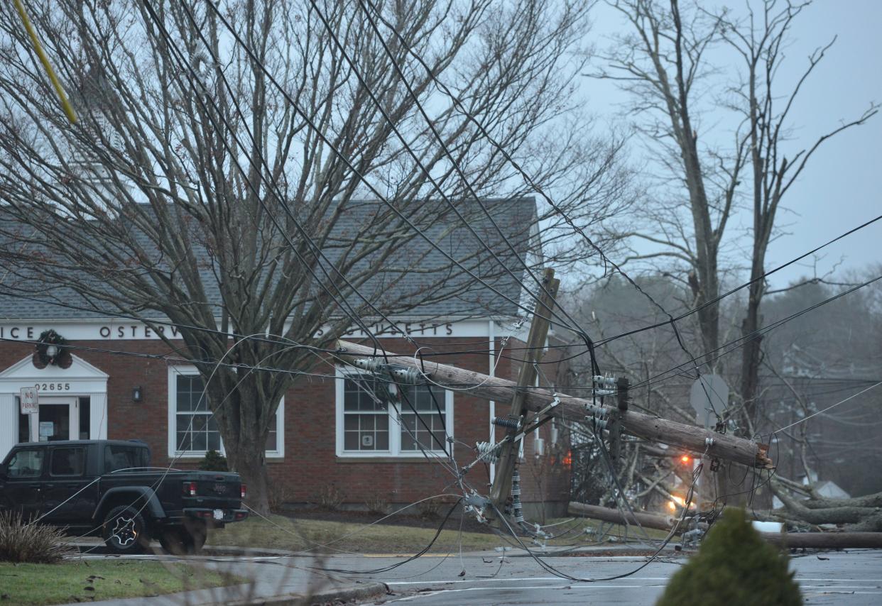 Crews responded to this downed utility pole at the intersection near West Bay Road and Main Street Monday. A tree fell on the utility wires Monday during heavy winds and rain.
