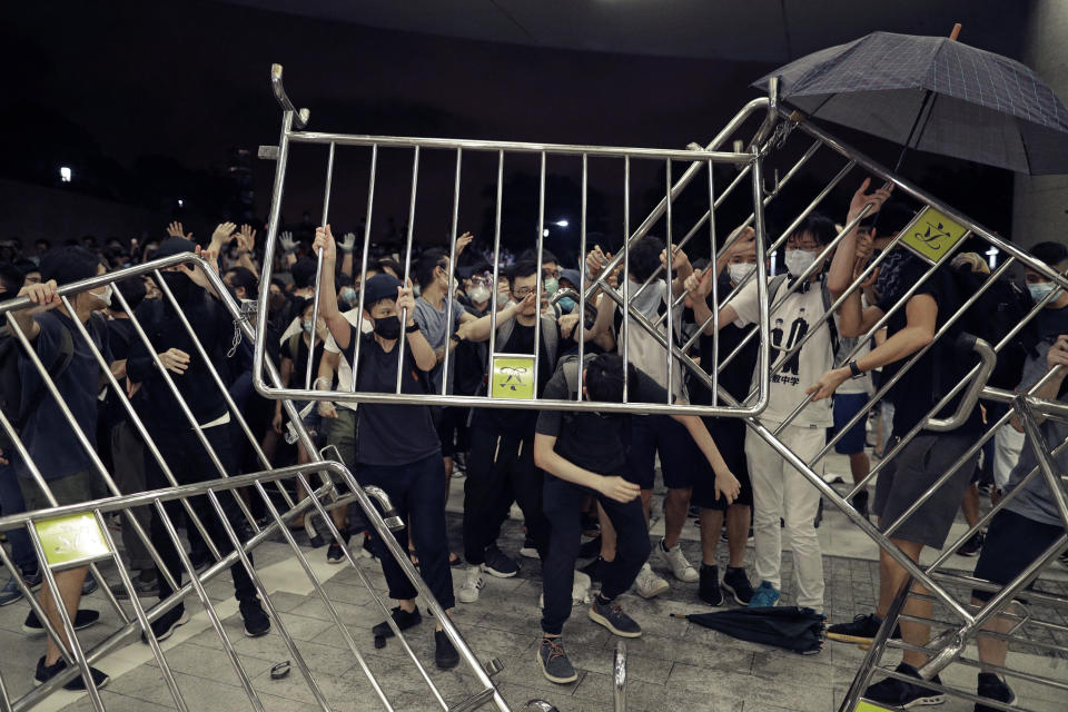 Protesters use barriers against the proposed amendments to the extradition law at the Legislative Council in Hong Kong during the early hours of Monday, June 10, 2019. The extradition law has aroused concerns that this legislation would undermine the city's independent judicial system as it allows Hong Kong to hand over fugitives to the jurisdictions that the city doesn't currently have an extradition agreement with, including mainland China, where a fair trial might not be guaranteed. (AP Photo/Vincent Yu)