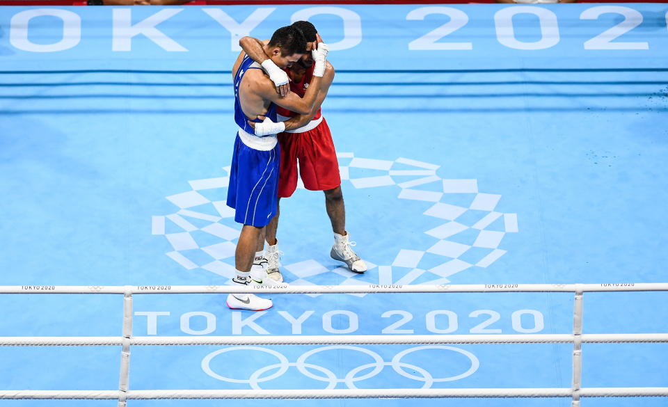 <p>Saken Bibossinov of Kazakhstan, left, and Galal Yafai of Great Britain embrace after their men's flyweight semi-final bout at the Kokugikan Arena during the 2020 Tokyo Summer Olympic Games in Tokyo, Japan. (Photo By Stephen McCarthy/Sportsfile via Getty Images)</p> 
