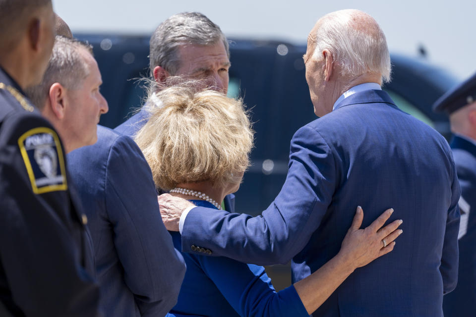 President Joe Biden, right, speaks with Charlotte, N.C., Mayor Vi Lyles, bottom center, and North Carolina Gov. Roy Cooper, top center, as he arrives on Air Force One at Charlotte Douglas International Airport, Thursday, May 2, 2024, in Charlotte, N.C. Biden is meeting with the families of law enforcement officers shot to death on the job. (AP Photo/Alex Brandon)