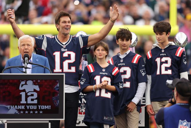 <p>Maddie Meyer/Getty Images</p> New England Patriots owner Robert Kraft speaks while former New England Patriots quarterback Tom Brady reacts while Brady's children, Vivian, Benjamin, and Jack, look on during a ceremony honoring Brady at halftime of New England's game against the Philadelphia Eagles