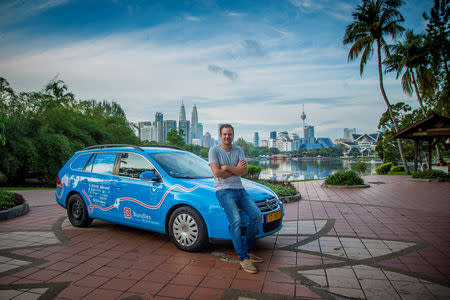 Dutch adventurer Wiebe Wakker on his electric car journey from the Netherlands to Australia, in Kuala Lumpur, Malaysia July 2017 in this picture obtained from social media. Picture taken July 2017. WIEBE WAKKER/PLUG ME IN PROJECT/via REUTERS