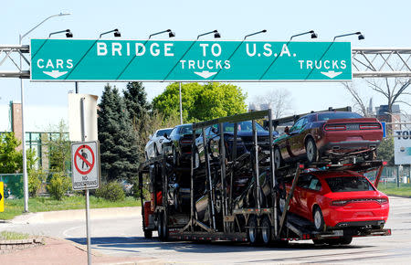 FILE PHOTO: A car hauler heading for Detroit, Michigan, drives on the lane to Ambassador Bridge in Windsor, Ontario, Canada., April 28, 2017. REUTERS/Rebecca Cook/File Photo