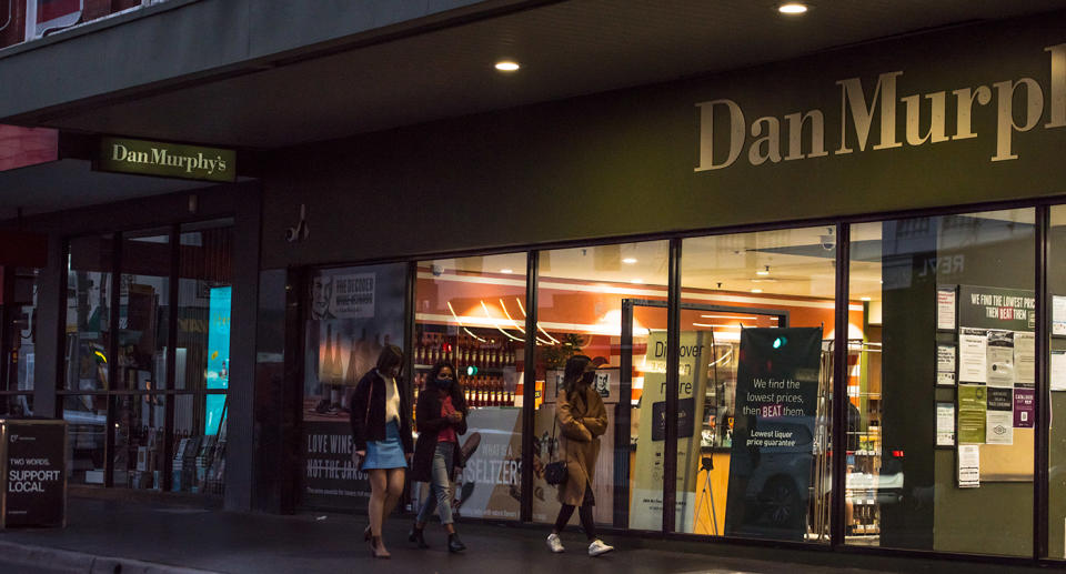 Dan Murphy&#39;s store with customers walking past.