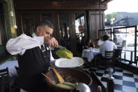 Salad Master Efrain Montoya prepares a Caesar salad at Ceasar's restaurant Thursday, June 27, 2024, in Tijuana, Mexico. Caesar salad has something to celebrate: It's turning 100. Italian immigrant Caesar Cardini is said to have invented the dish on July 4, 1924, at his restaurant, Caesar's Place, in Tijuana, Mexico. (AP Photo/Gregory Bull)