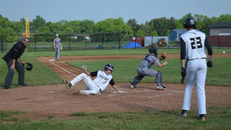 Burlington Township's Ryan Capriotti (11) slides safely home as Northern Burlington catcher Franklin Peters awaits the throw after Matt Torreto's RBI single in the sixth inning of their BCSL Liberty Division game on Thursday, May 19, 2022.