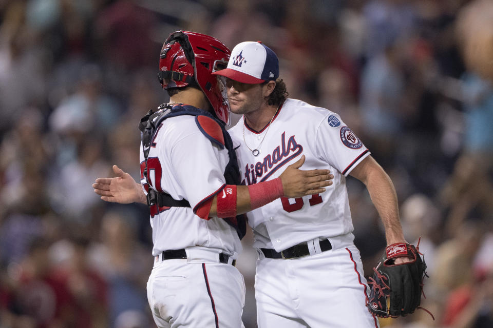 Washington Nationals relief pitcher Kyle Finnegan, right, and catcher Keibert Ruiz celebrate the team's win in a baseball game against the San Diego Padres in Washington, Wednesday, May 24, 2023. (AP Photo/Manuel Balce Ceneta)