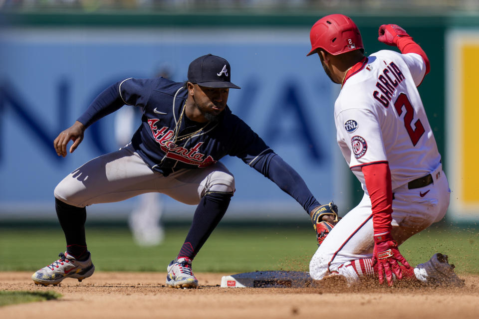Atlanta Braves second baseman Ozzie Albies tags out Washington Nationals' Luis Garcia on the steal attempt of second base during the fourth inning of a baseball game at Nationals Park, Sunday, April 2, 2023, in Washington. (AP Photo/Alex Brandon)