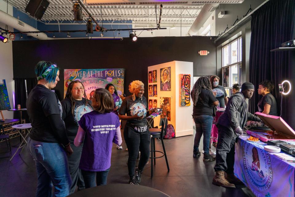 Attendees socialize and enjoy free food, drinks, and resources during the Transgender Day of Visibility Power at the Polls event at The Avenue Blackbox Theatre on Friday, March 31, 2023.