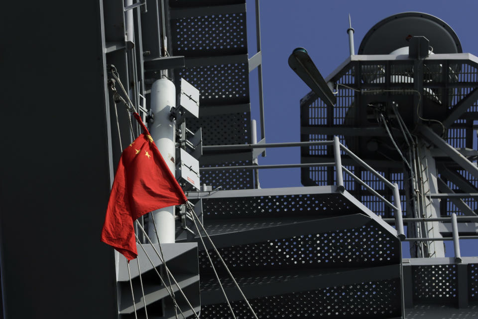 A China national flag is seen flying on the U.S. Navy USS Ronald Reagan aircraft carrier in Hong Kong, Wednesday, Nov. 21, 2018. The USS Reagan docked in Hong Kong on Wednesday, days after a pair of American B-52 bombers flew over the disputed South China Sea. (AP Photo/Kin Cheung)