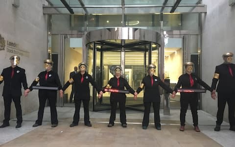 Environment protesters from Extinction Rebellion glue themselves to London Stock Exchange - Credit: Mason Boycott-Owen/PA