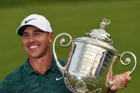 Aug 12, 2018; Saint Louis, MO, USA; Brooks Koepka celebrates with the Wanamaker Trophy after winning the PGA Championship golf tournament at Bellerive Country Club. John David Mercer-USA TODAY Sports