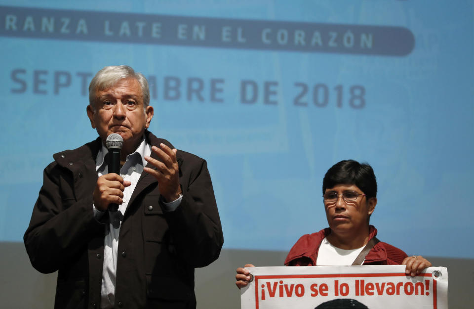 President-elect Andres Manuel Lopez Obrador speaks next to Maria Elena Guerrero, mother of one of the 43 college students who disappeared on Sept. 26, 2014, at the Memory and Tolerance Museum in Mexico City, Wednesday, Sept. 26, 2018. Later in the day, family members and supporters, who do not accept the findings of government investigations, will march to mark four years since the students disappearance at the hands of police. (AP Photo/Rebecca Blackwell)