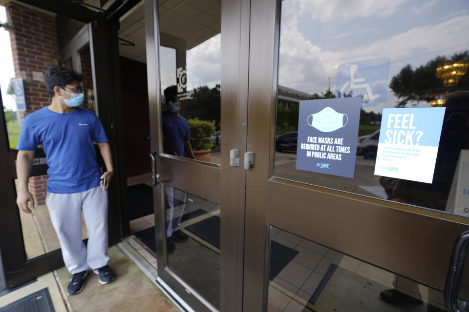 Usage of required face masks are posted throughout Jackson State University during an open COVID-19 vaccination site sponsored by the university and the Jackson-Hinds Comprehensive Health Center in Jackson, Miss., Tuesday, Aug. 3, 2021. (AP Photo/Rogelio V. Solis)