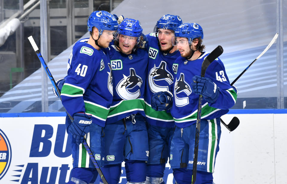 EDMONTON, ALBERTA - AUGUST 30: Tyler Toffoli #73 of the Vancouver Canucks celebrates with Elias Pettersson #40, Quinn Hughes #43 and Bo Horvat #53 after Toffoli scored in the second period of Game Four of the Western Conference Second Round of the 2020 NHL Stanley Cup Playoff between the Vegas Golden Knights and the Vancouver Canucks at Rogers Place on August 30, 2020 in Edmonton, Alberta. (Photo by Andy Devlin/NHLI via Getty Images)