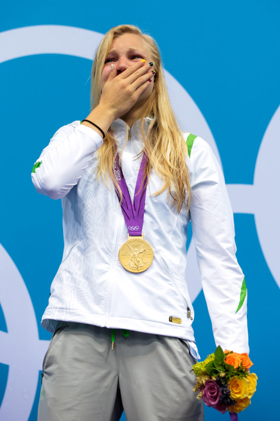 LONDON, ENGLAND - JULY 30: Ruta Meilutyte of Lithuania reacts as she receives her gold medal during the medal ceremony for the Women's 100m Breaststroke on Day 3 of the London 2012 Olympic Games at the Aquatics Centre on July 30, 2012 in London, England. (Photo by Adam Pretty/Getty Images)