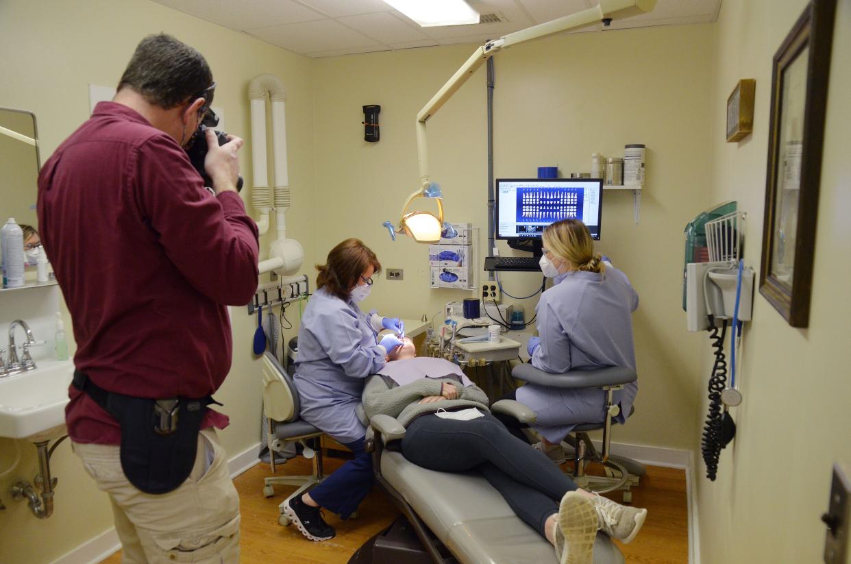 Bob Mackowski of Open Aperture Photography takes photos of MERCI Clinic staff Daphne Ellison, Molly Holton, and Alyssa Stich during a photo shoot last Friday. Over the next year, Mackowski will be donating a free marketing shoot to 12 nonprofits in the New Bern area.