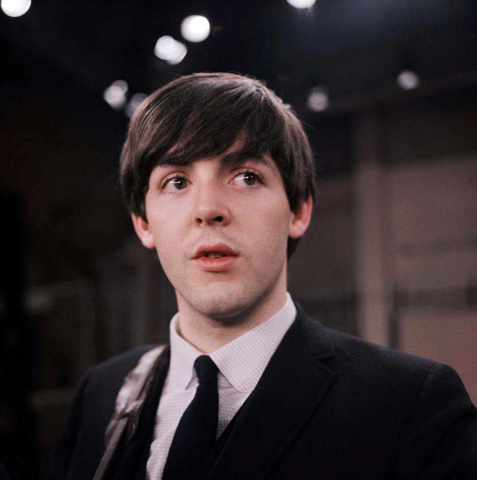 FILE - This Feb. 1964 file photo shows the Beatles' Paul McCartney on the set of the "Ed Sullivan Show," in New York. McCartney and Ringo Starr will attend the Recording Academy's Special Merit Awards ceremony, on Saturday, Jan. 25, 2014, where the Beatles will be honored with a lifetime achievement award, in Los Angeles. (AP Photo/File)