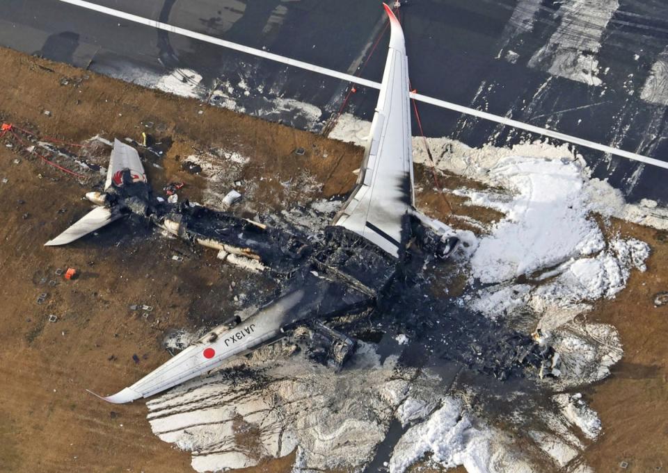 This aerial photo shows the burnt-out Japan Airlines plane at Haneda airport on Wednesday