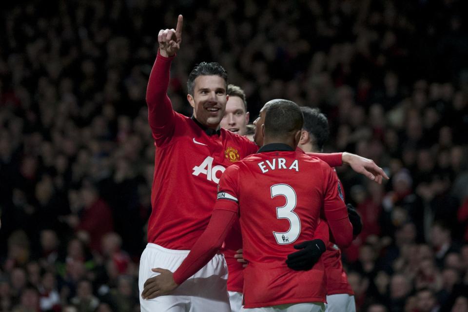Manchester United's Robin van Persie, left, celebrates with teammates after scoring against Cardiff City during their English Premier League soccer match at Old Trafford Stadium, Manchester, England, Tuesday Jan. 28, 2014. (AP Photo/Jon Super)