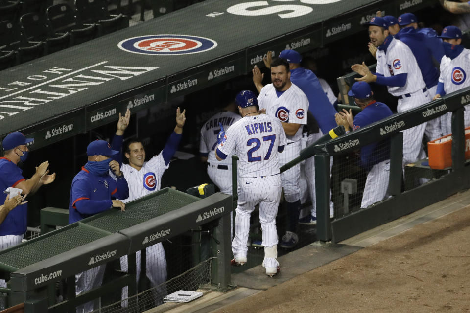 Chicago Cubs' Jason Kipnis (27) is congratulated by teammates after hitting a solo home run against the Pittsburgh Pirates during the fourth inning of a baseball game in Chicago, Friday, July 31, 2020. (AP Photo/Nam Y. Huh)