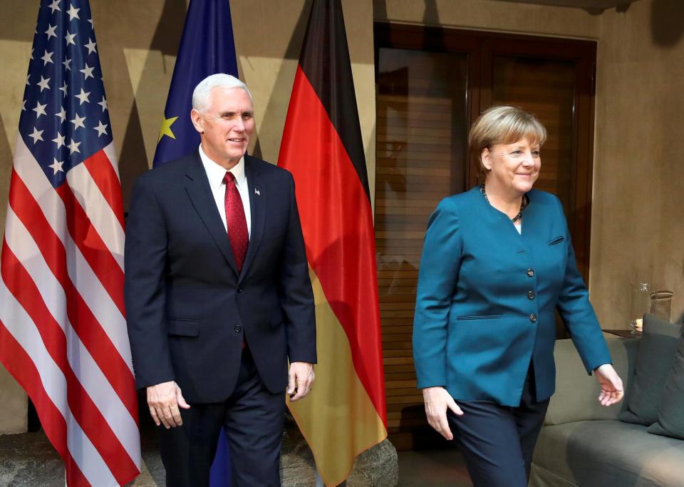 Angela Merkel walks with US Vice President Mike Pence before their meeting at the Munich Security Conference: REUTERS/Michael Dalder