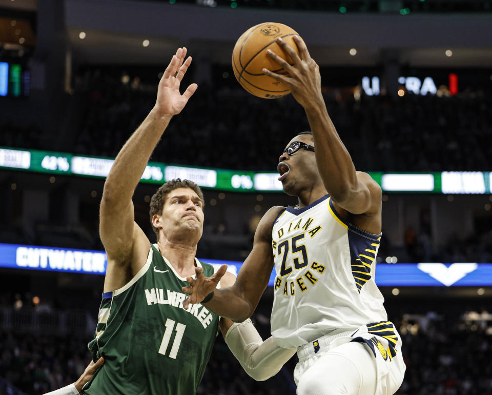 Indiana Pacers' Jalen Smith (25) drives against the Milwaukee Bucks' Brook Lopez during the first half of an NBA basketball, Monday, Jan. 1, 2024, in Milwaukee. (AP Photo/Jeffrey Phelps)