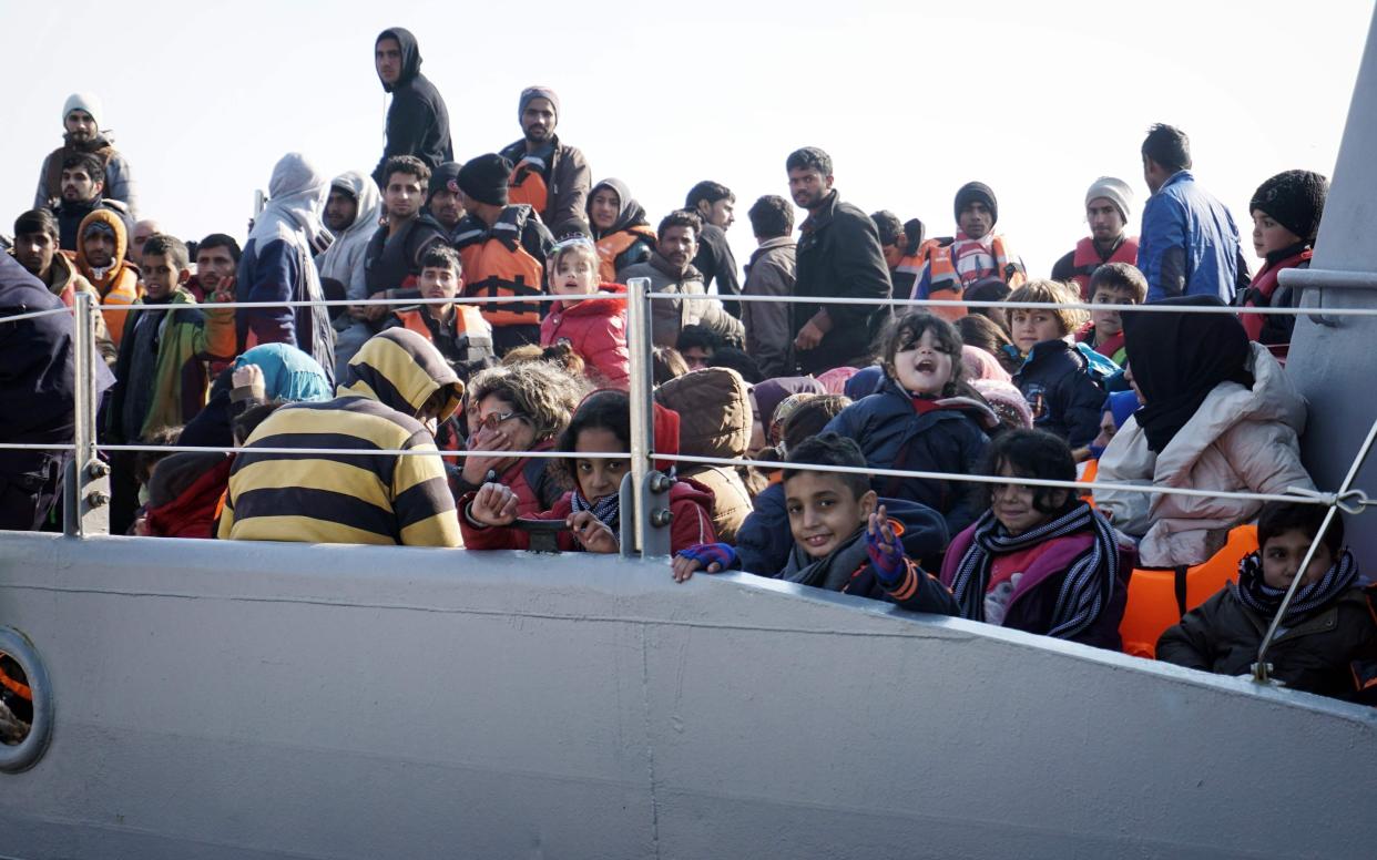 Migrants and refugees aboard a Greek coast guard boat on the island of Lesbos after being rescued in 2016 - AFP