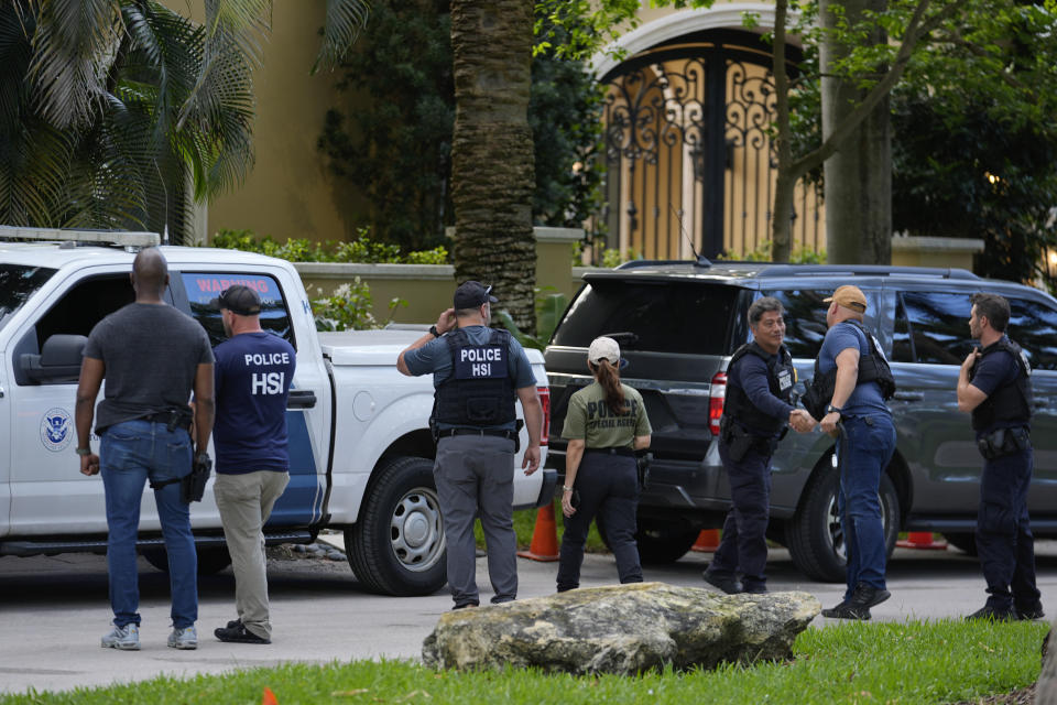 Law enforcement agents stand at the entrance to a property belonging to rapper Sean "Diddy" Combs, Monday, March 25, 2024, on Star Island in Miami Beach, Fla. Two properties belonging to Combs in Los Angeles and Miami were searched by federal Homeland Security Investigations agents and other law enforcement as part of an ongoing sex trafficking investigation by federal authorities in New York, two law enforcement officials told The Associated Press. (AP Photo/Rebecca Blackwell)