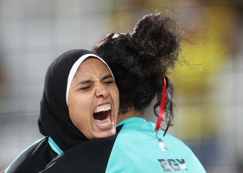 <p>Egypt’s Doaa Elghobashy, left, hugs her teammate Nada Meawad, right, during a women’s beach volleyball match against Germany at the 2016 Summer Olympics in Rio de Janeiro, Brazil, Sunday, Aug. 7, 2016. (AP Photo/Petr David Josek) </p>