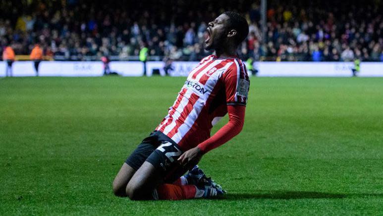 Lincoln defender TJ Eyoma celebrates scoring a goal