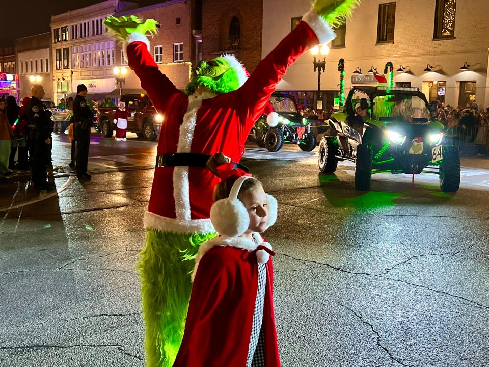 The Grinch and Cindy Loo Hoo greet spectators during the 37th annual Columbia Main Street Christmas Parade.