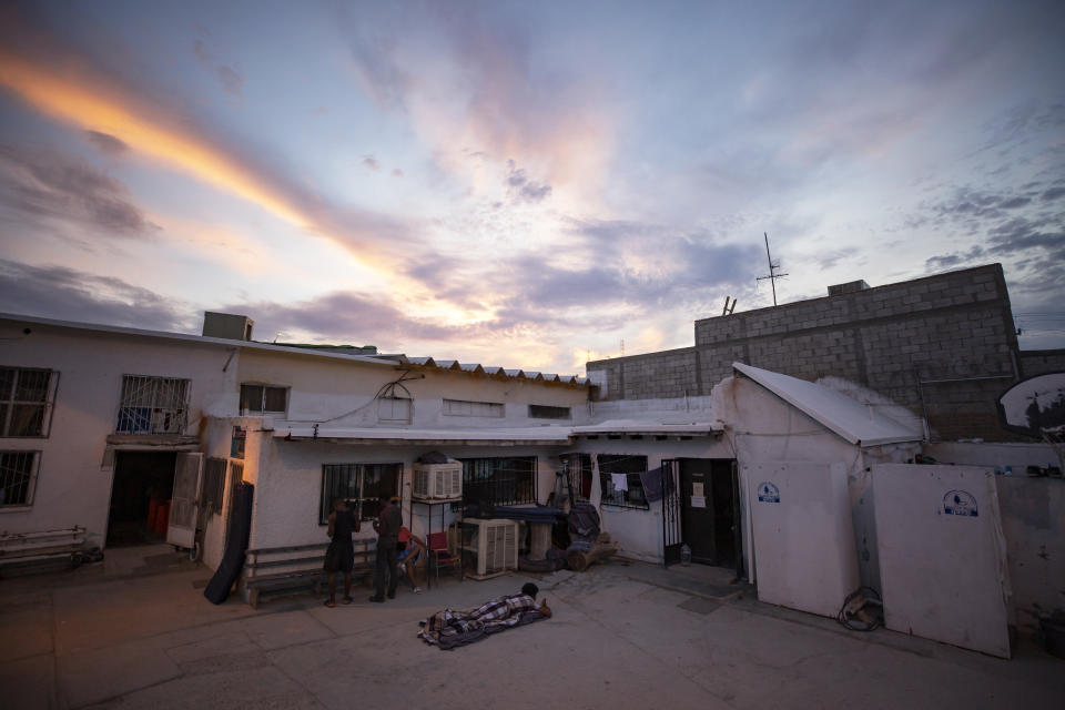 In this July 27, 2019, photo, a migrant wakes up before sunrise at El Buen Pastor shelter for migrants in Cuidad Juarez, Mexico. (AP Photo/Gregory Bull)