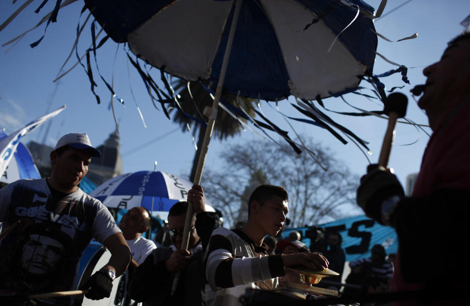 People bang drums as they attend a demonstration at Plaza de Mayo in Buenos Aires, Argentina, Wednesday, June 27, 2012. A strike and demonstration called by union leader Hugo Moyano demands steps that would effectively reduce taxes on low-income people, among other measures. (AP Photo/Natacha Pisarenko)