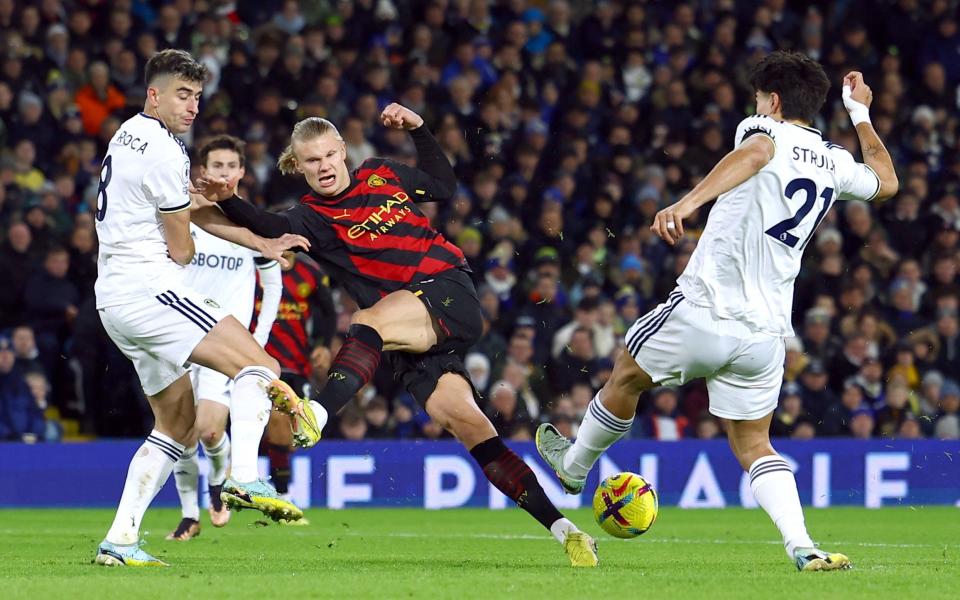 Manchester City's Erling Braut Haaland in action with Leeds United's Pascal Struijk and Marc Roca - REUTERS