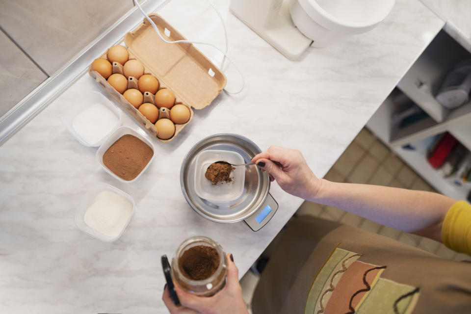 Measuring cocoa powder on a kitchen scale.