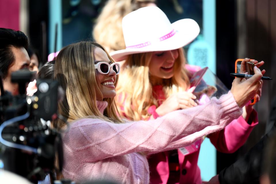 Robbie poses for photos with fans during a "Barbie" fan event in Sydney on June 30.