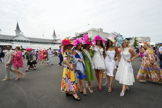 People walk on the grounds of Churchill Downs before the 149th running of the Kentucky Derby horse race Saturday, May 6, 2023, in Louisville, Ky. (AP Photo/Julio Cortez)