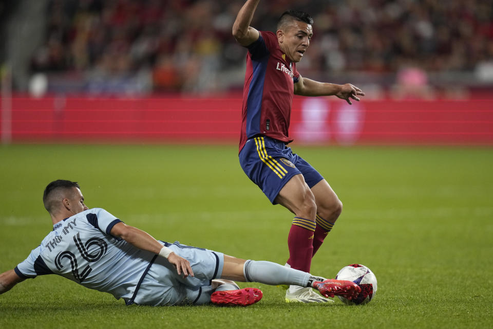 Sporting Kansas City midfielder Erik Thommy (26) defends against Real Salt Lake midfielder Braian Ojeda during the first half of an MLS soccer match Saturday, Oct. 7, 2023, in Sandy, Utah. (AP Photo/Rick Bowmer)