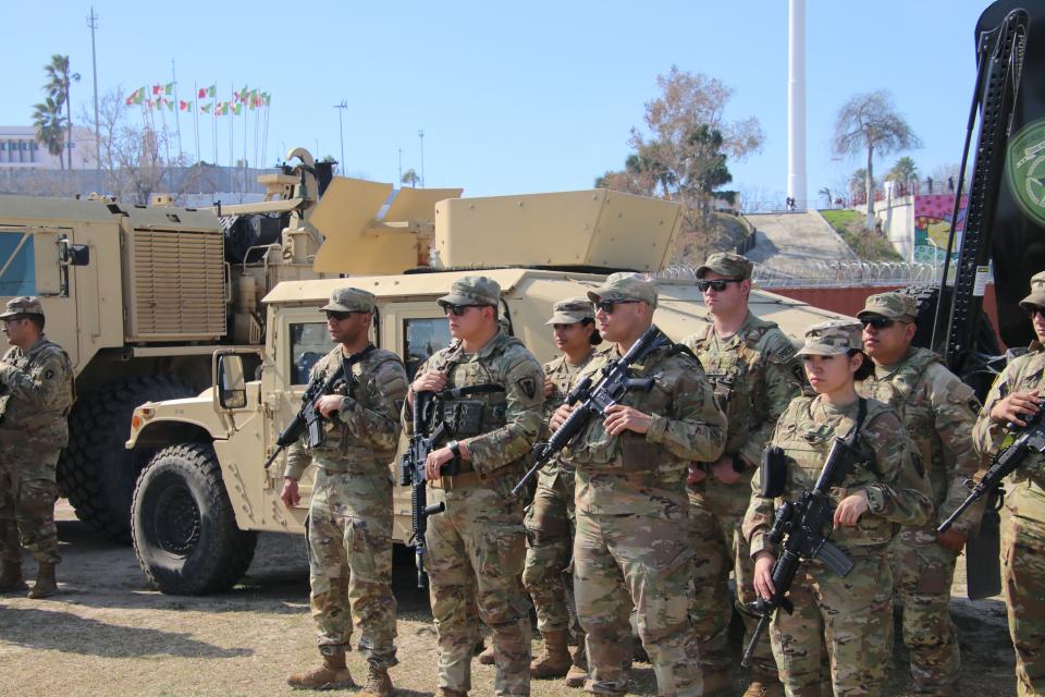 Texas National Guard members stand in the background at a press conference in Eagle Pass, Texas.