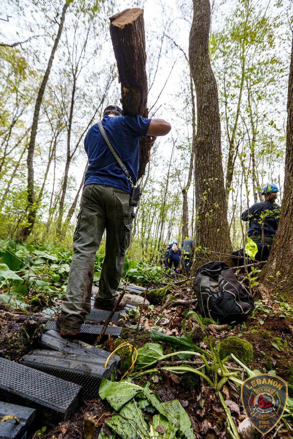 Rescue personnel used logs and other equipment to make a more stable path through the swampy woods (LVFD)