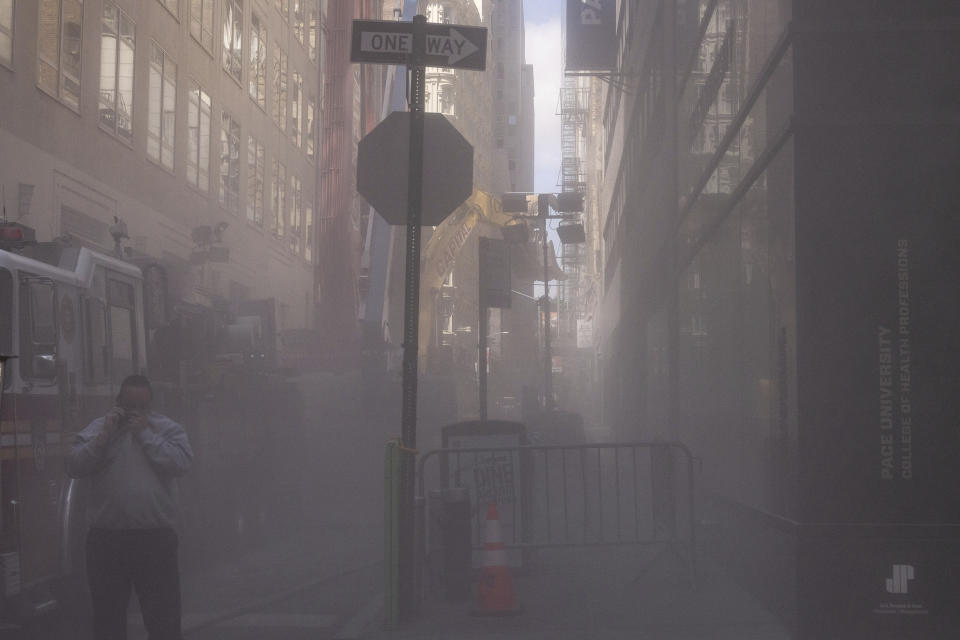 A street is covered in dust after facade of a partially collapsed parking garage is demolished in the Financial District of New York, Wednesday, April 19, 2023. (AP Photo/Yuki Iwamura)