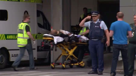 Emergency services personnel transport a stretcher carrying a person at a hospital, after reports that several shots had been fired, in central Christchurch, New Zealand March 15, 2019, in this still image taken from video. TVNZ/via REUTERS TV