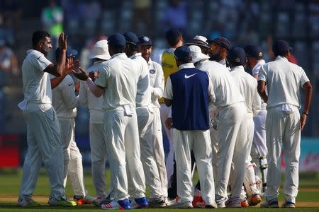 India's Ravichandran Ashwin (L) celebrates with team mates the wicket of England's Ben Stokes during the Mumbai cricket test at Wankhede Stadium, December 9, 2016. REUTERS/Danish Siddiqui