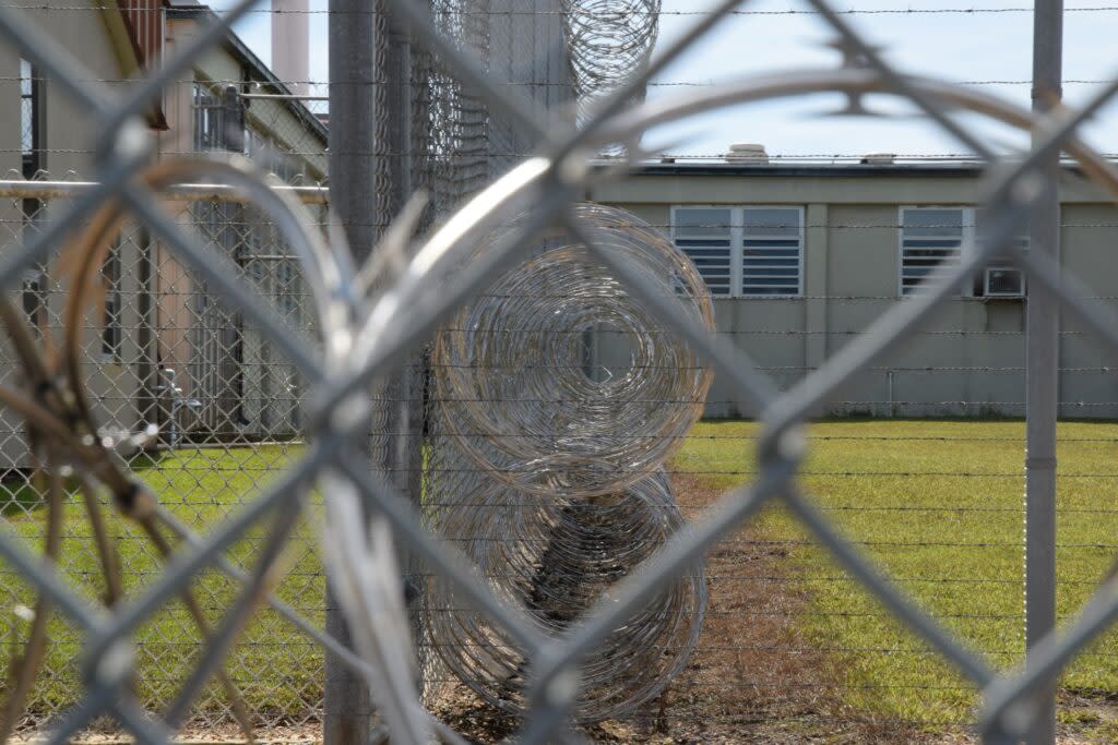 Barbed wire seen behind a fence at an Alabama prison.