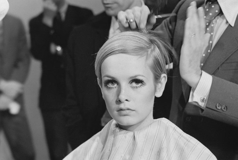 Leonard of London cuts model Twiggy's hair during a press conference announcing her television special.