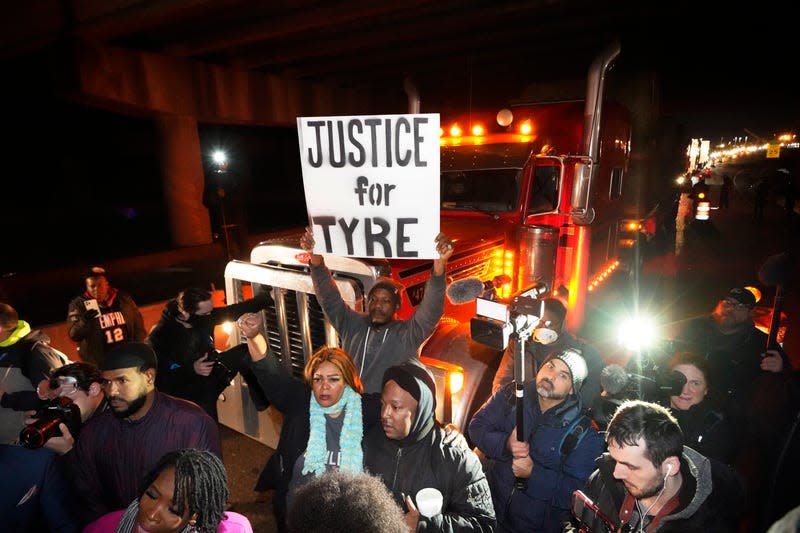 Protesters march down the street Friday, Jan. 27, 2023, in Memphis, Tenn., as authorities release police video depicting five Memphis officers beating Tyre Nichols, whose death resulted in murder charges and provoked outrage at the country’s latest instance of police brutality. 